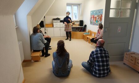 Eine Mitarbeiterin der Frühforderung zeigt Besuchern die Räume der Beratungstelle